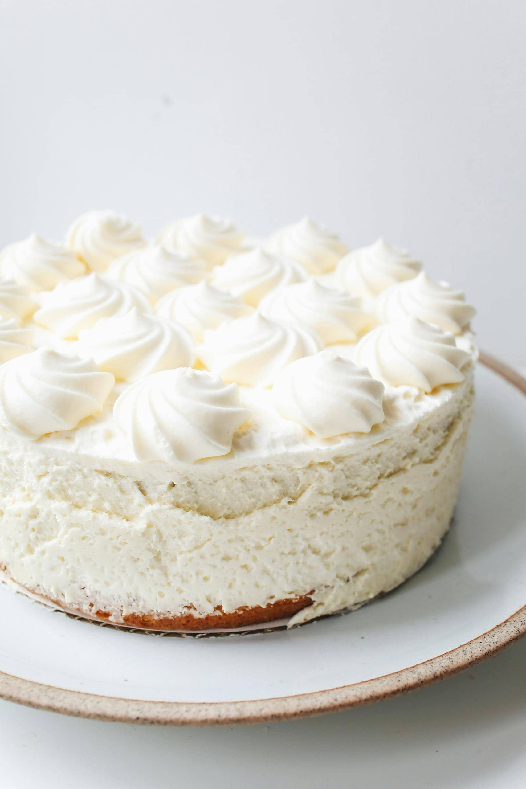 Indulge in this creamy cheesecake topped with fluffy whipped cream. Perfect dessert for any occasion.