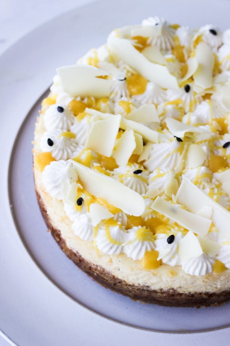 White chocolate cheesecake with passion fruit curd in a close up shot.