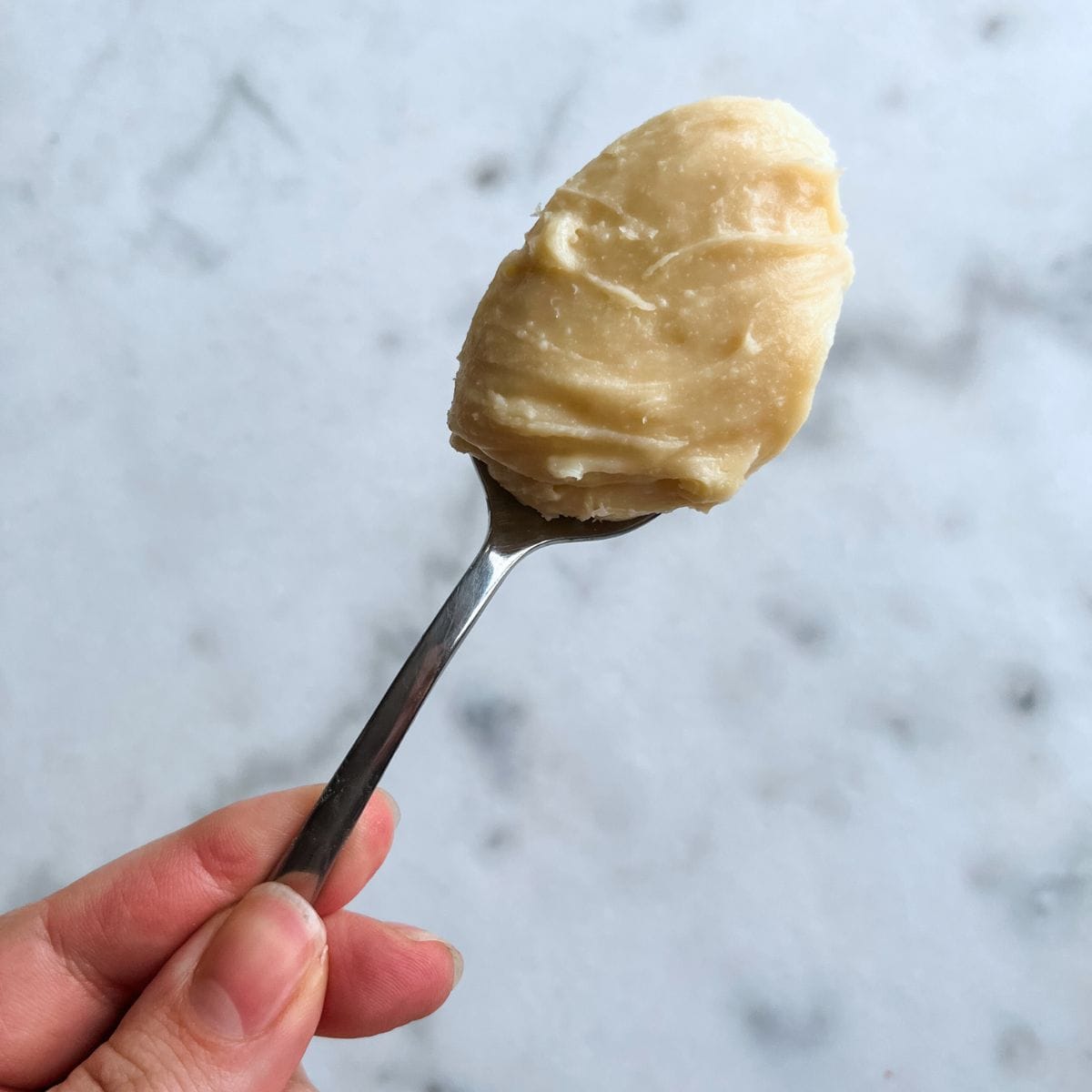 Cream cheese fudge in a spoon ready to be served