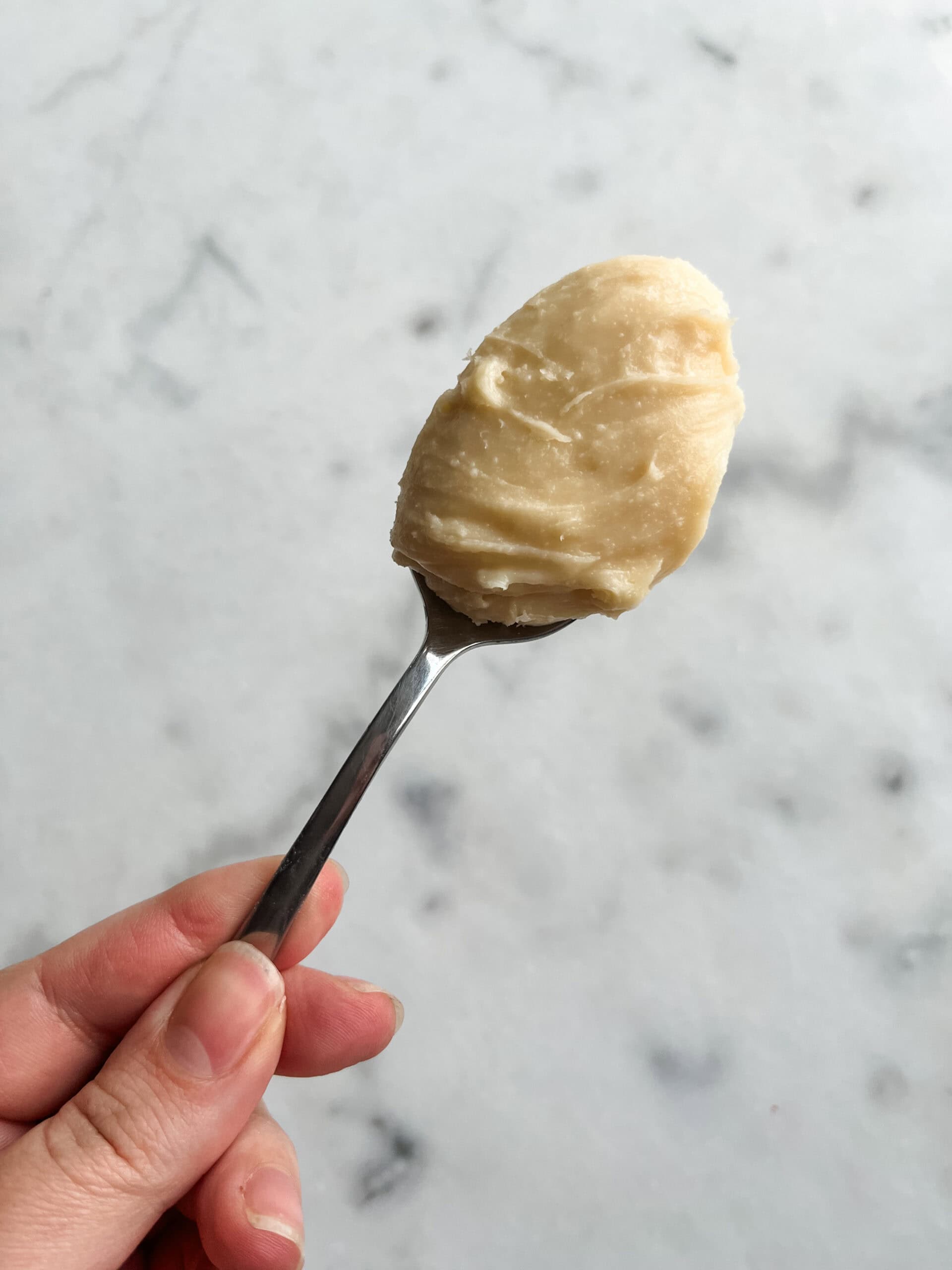 Cream Cheese fudge in a spoon ready to be served.