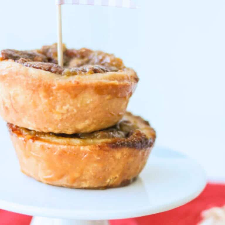 Pecan buttertarts on top of a cake stand