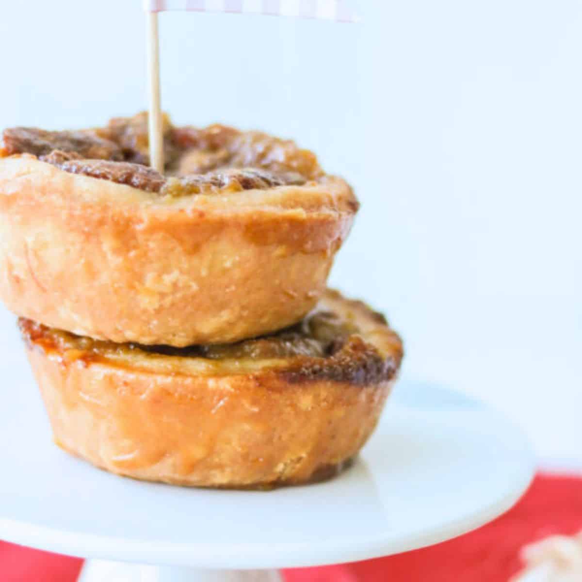 Pecan buttertarts on top of a cake stand