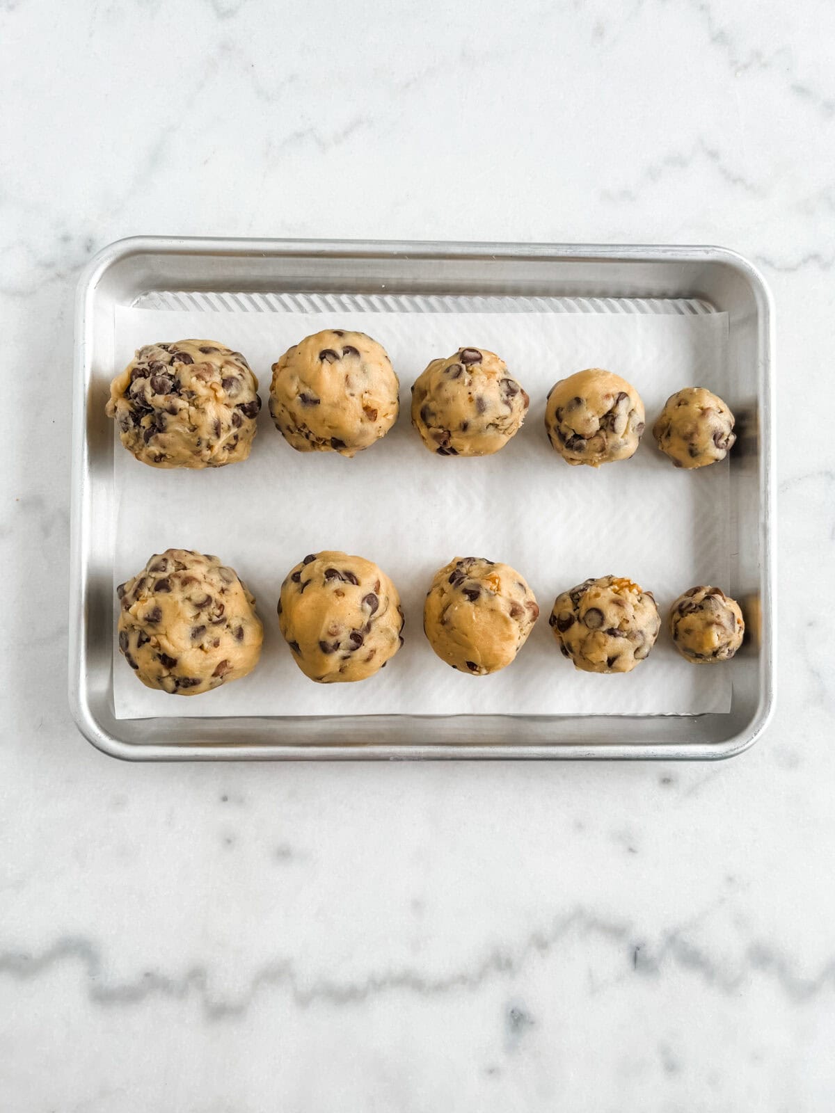 Cookies laying on a cookie tray from biggest to smallest, in accurate measurements.