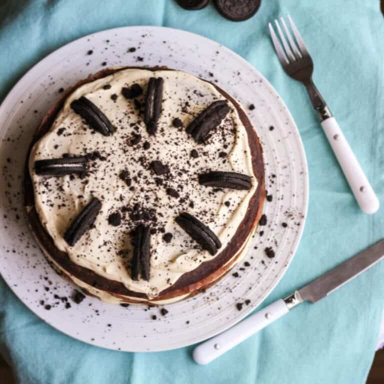 Oreo crepe cake with visible layers of crepes, whipped cream, and crushed Oreos.