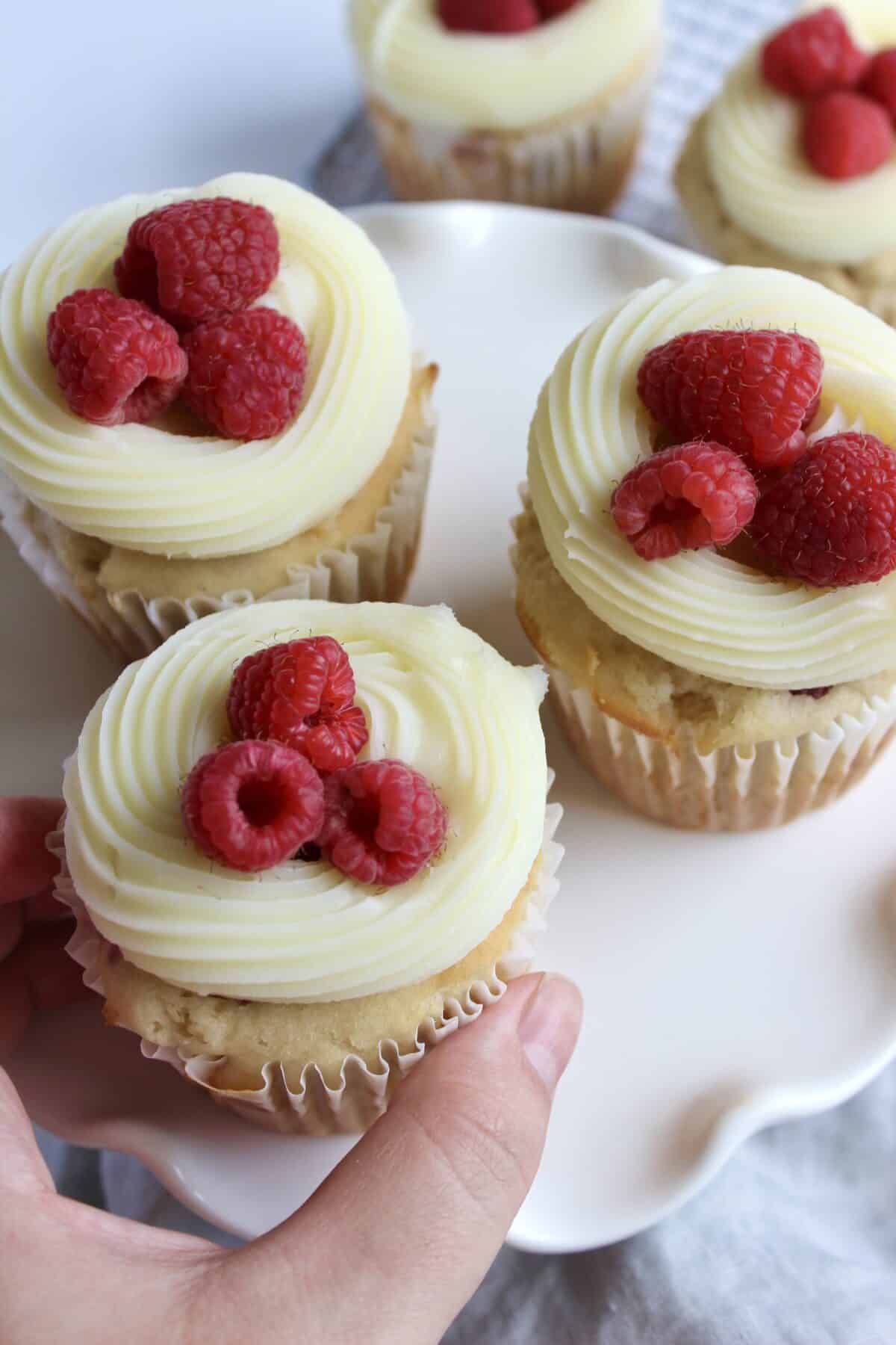 Picking up a white chocolate raspberry cupcake