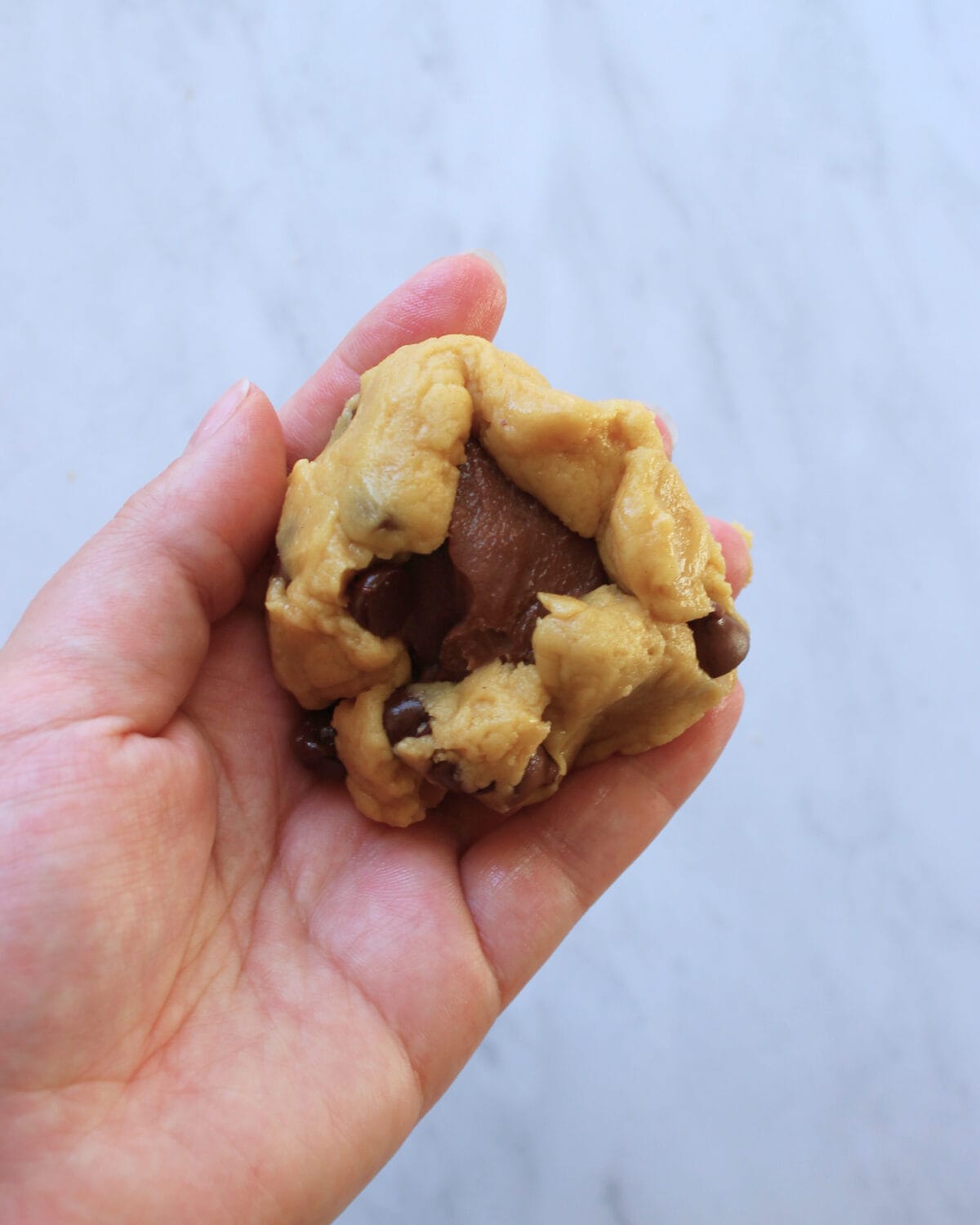 Chocolate chip cookie stuffed with a portion of creamy chocolate fudge