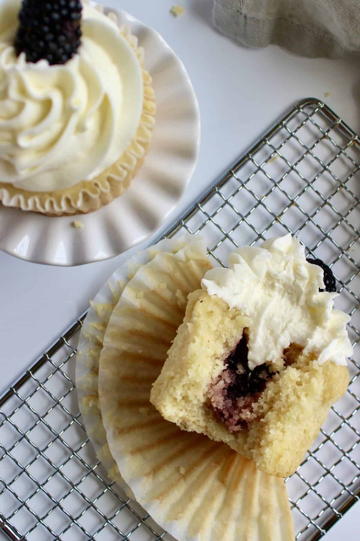 Lemon blackberry cupcakes decorated with blackberries and filled with blackberry jam