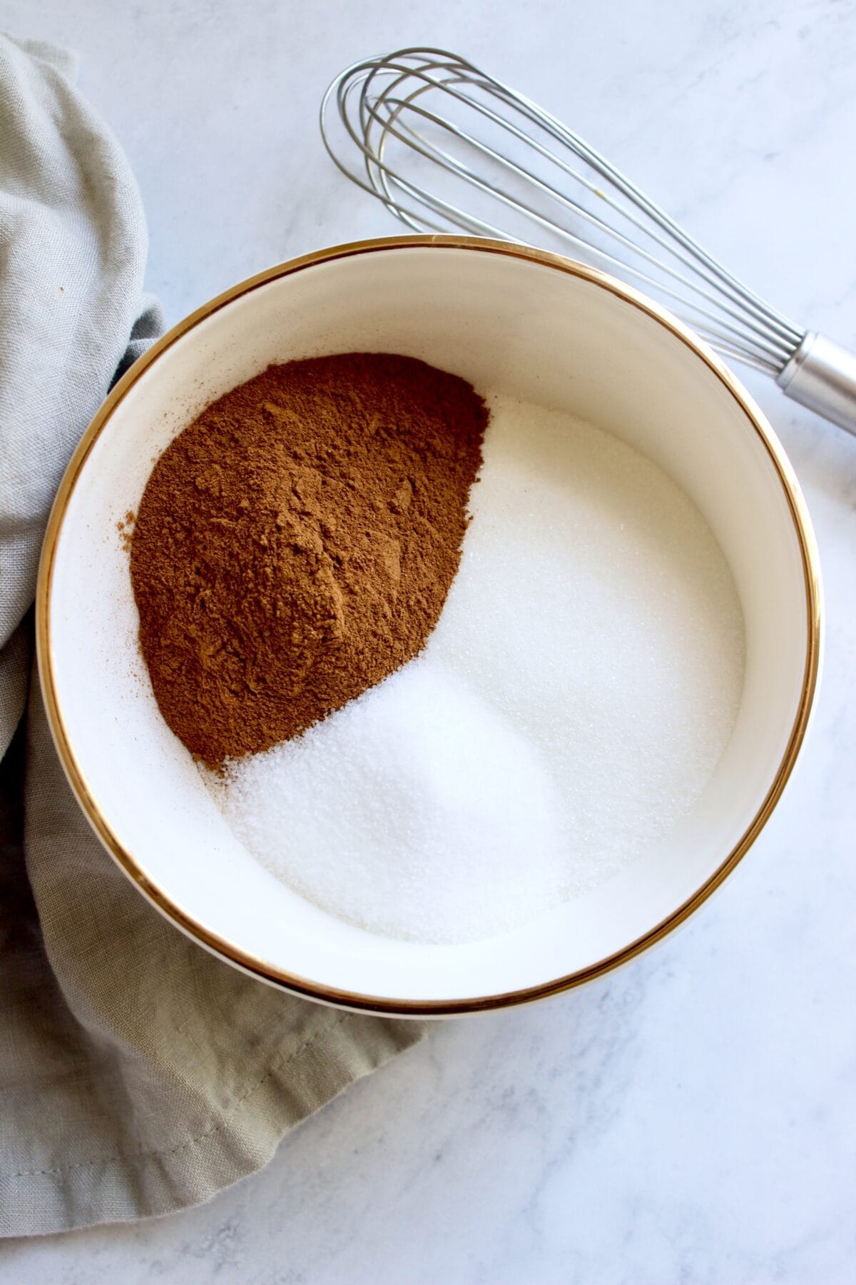 Ingredients for homemade cinnamon sugar seasoning laid out in a small bowl.