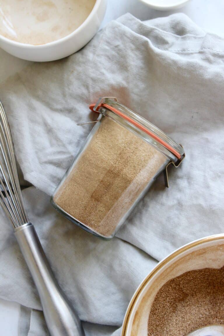 Jar of homemade cinnamon sugar made with granulated sugar and ground cinnamon.