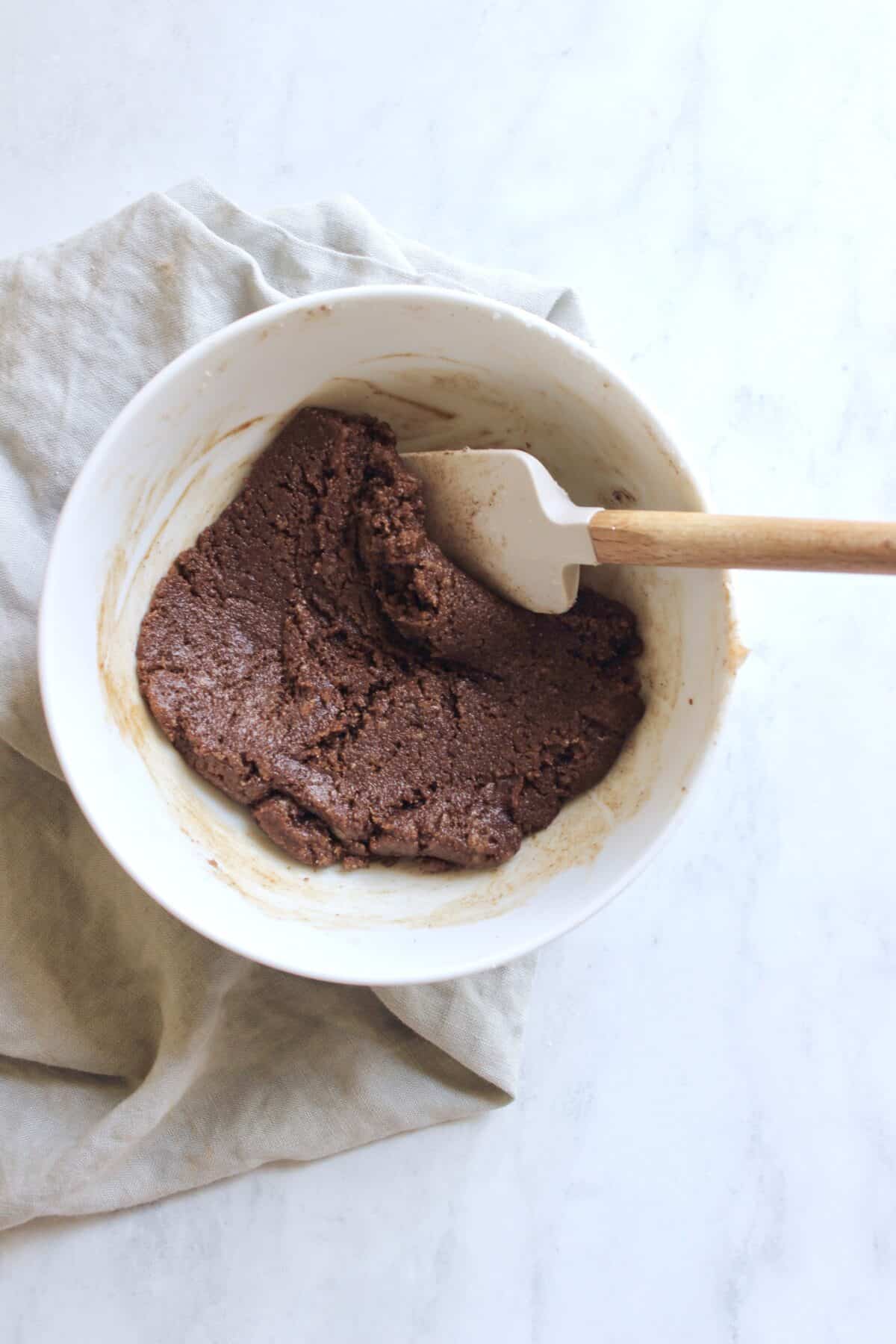 Mixing cinnamon and sugar with coconut oil to make homemade cinnamon baking chips.