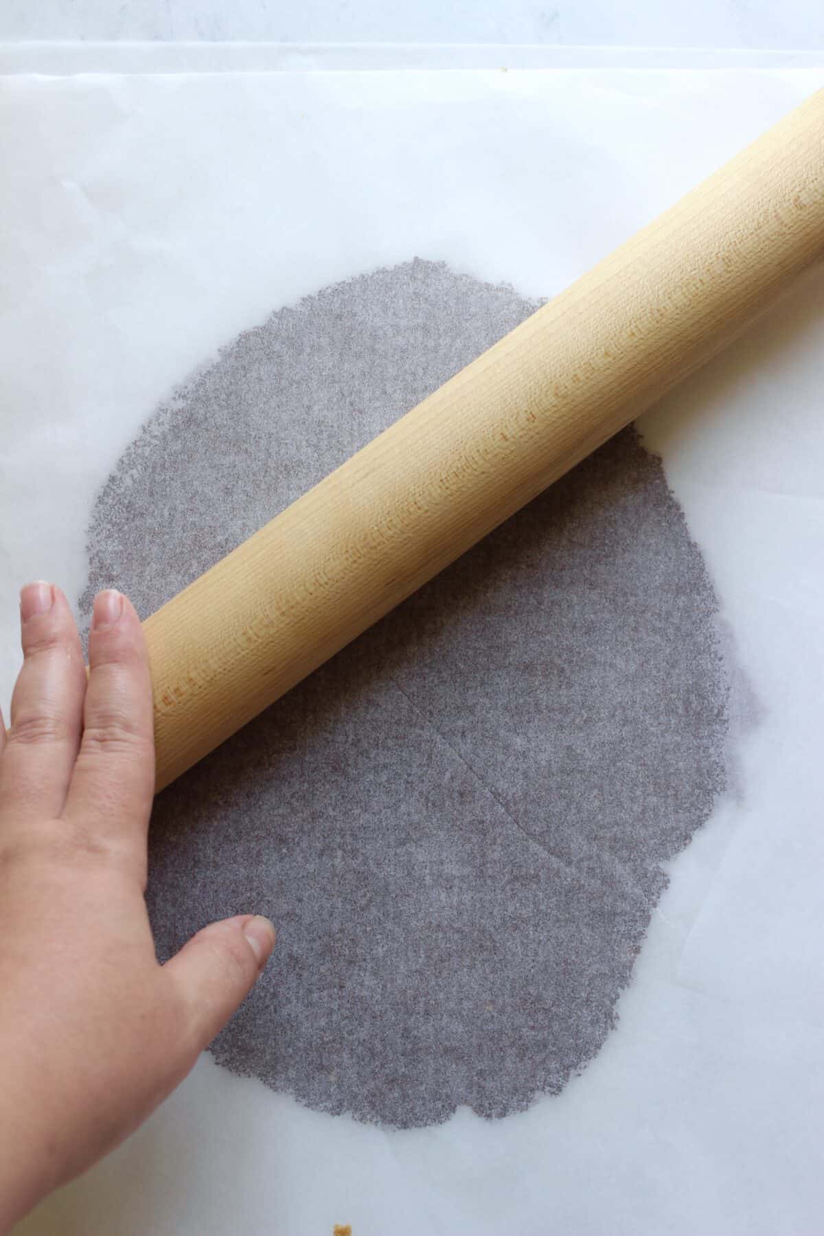 Rolling the cinnamon chip mixture evenly before baking.