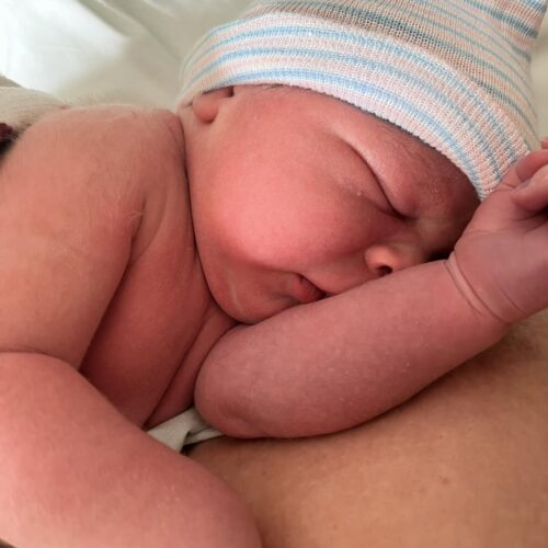 Newborn baby on mom's arms